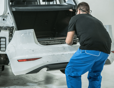 an auto mechanic repairs one of the rear parts of 2025 01 07 16 01 24 utc